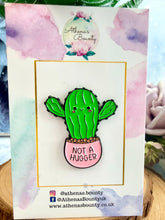 Load image into Gallery viewer, Cactus-shaped pin with 'Not a Hugger' text on a branded card