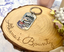 Load image into Gallery viewer, “Books are cheaper than therapy and twice as effective” Keyring
